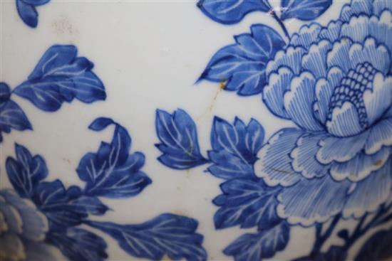 A Chinese blue and white painted lidded baluster vase, painted with blossoming peonies height 45cm, cracked